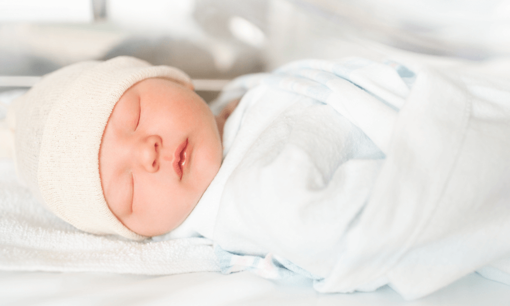 Reduce risk of SIDS by swaddling newborns to make them more secure. Baby swaddled.